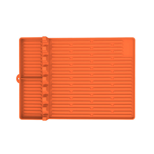 Orange silicone baking mat with textured surface on a white background